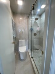 Contemporary bathroom featuring a glass shower and modern fixtures.