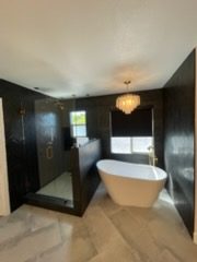 Elegant bathroom featuring a freestanding bathtub and glass-enclosed shower.